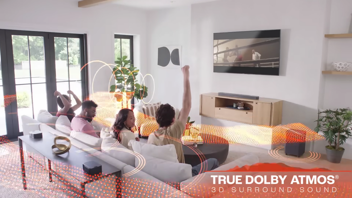 Family enjoying Dolby Atmos 3D surround sound in a modern living room with a soundbar, wireless speakers and overhead audio effects in NZ.