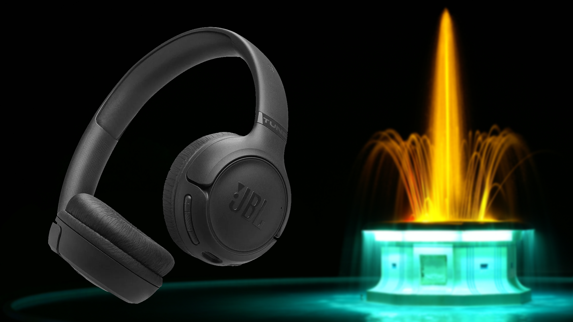 Black JBL headphones with the illuminated Tom Parker Fountain in Napier, New Zealand, softly blurred behind them - Headphones at Tech Supply Shed NZ