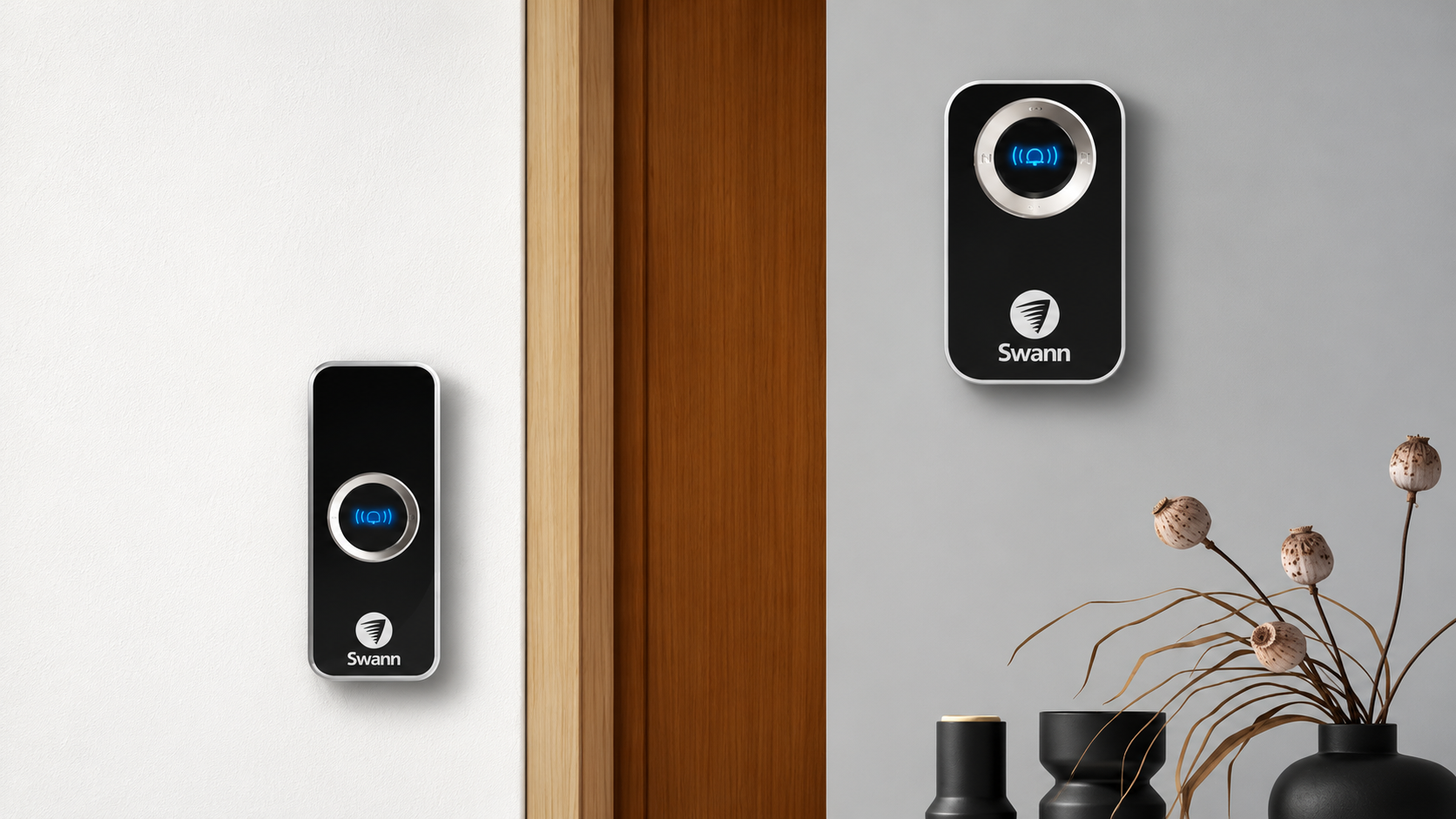 Two Swann wireless doorbell units mounted on either side of a timber doorway, featuring black housings, silver trim and illuminated blue buttons in a modern home setting.