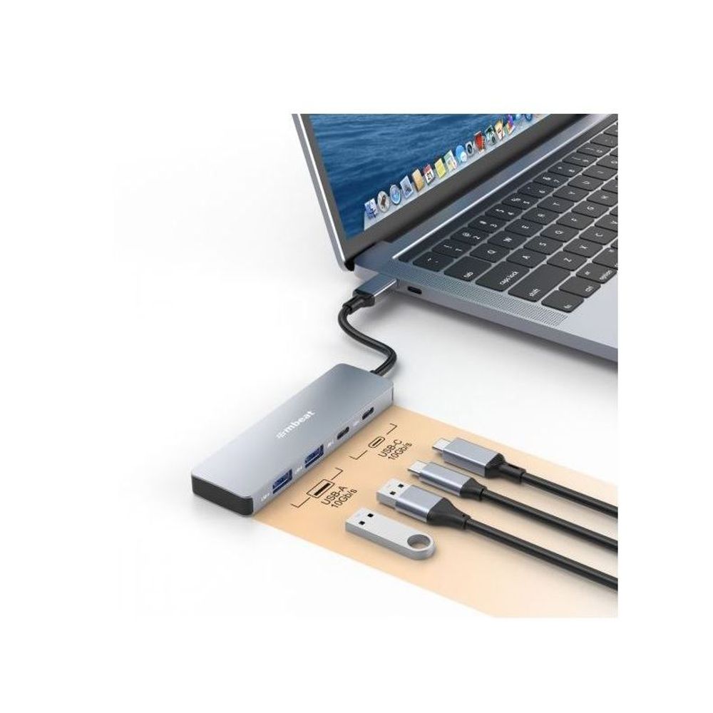 Grey USB-C hub connected to a laptop with several adapters and cables