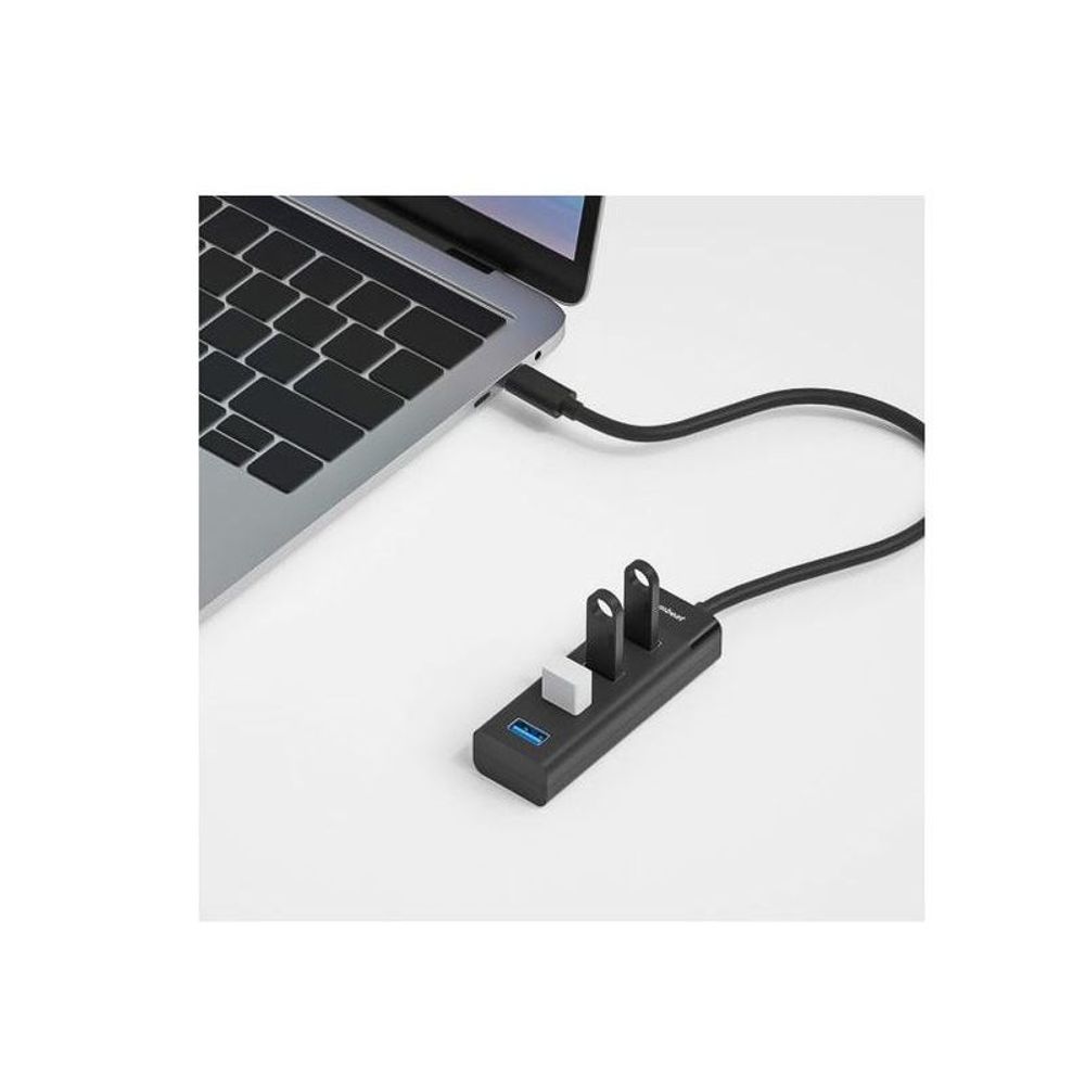 Black mbeat USB-C hub connected to laptop, showing four blue USB-A ports