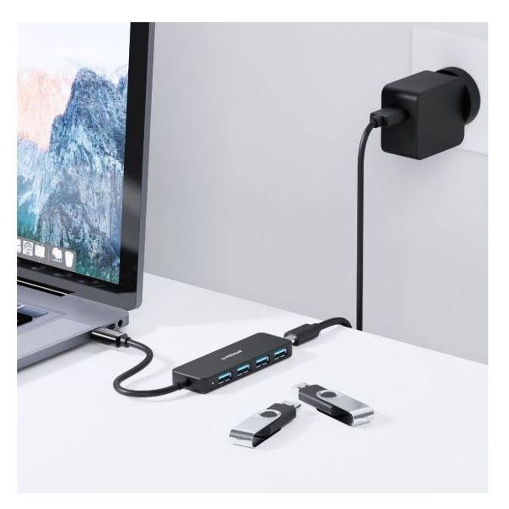 Black USB-C hub with four blue ports and USB-C DC connector, plus included adapters