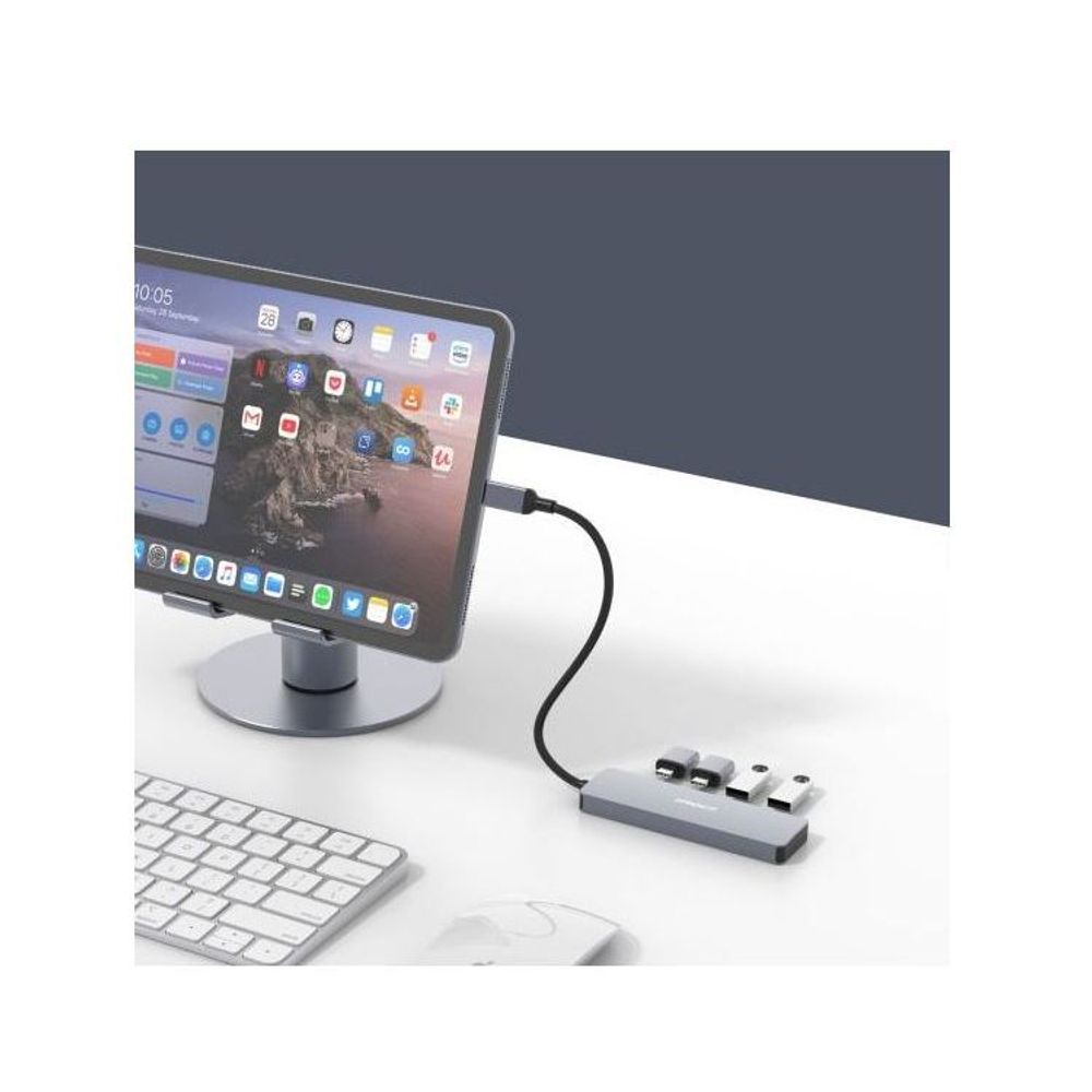 Grey 4-port USB-C hub connected to a tablet and external devices