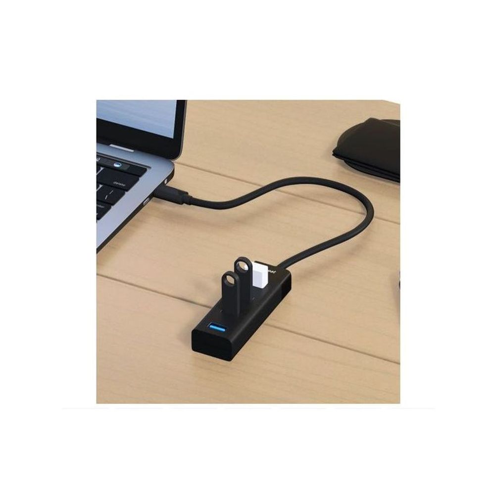 Black mbeat USB-C hub with four blue USB-A ports connected to a laptop by cable