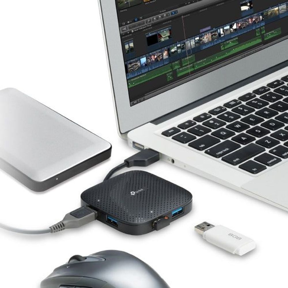 Portable USB hub connected to laptop with mouse and flash drive plugged in