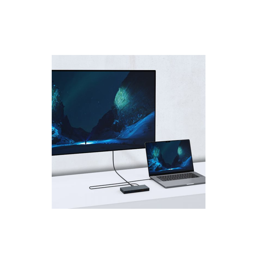 Space grey USB-C triple display dock connected to a laptop and display