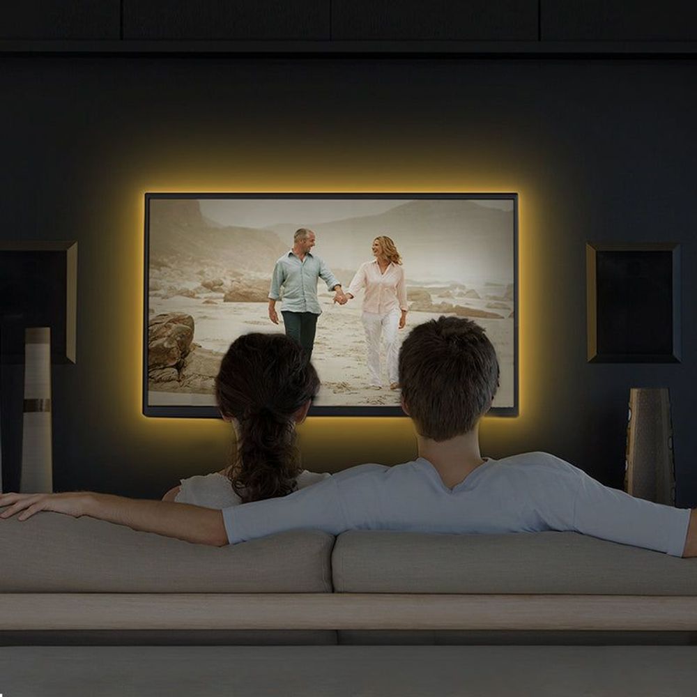 Smart Wi-Fi light strip glowing along the wall behind a TV