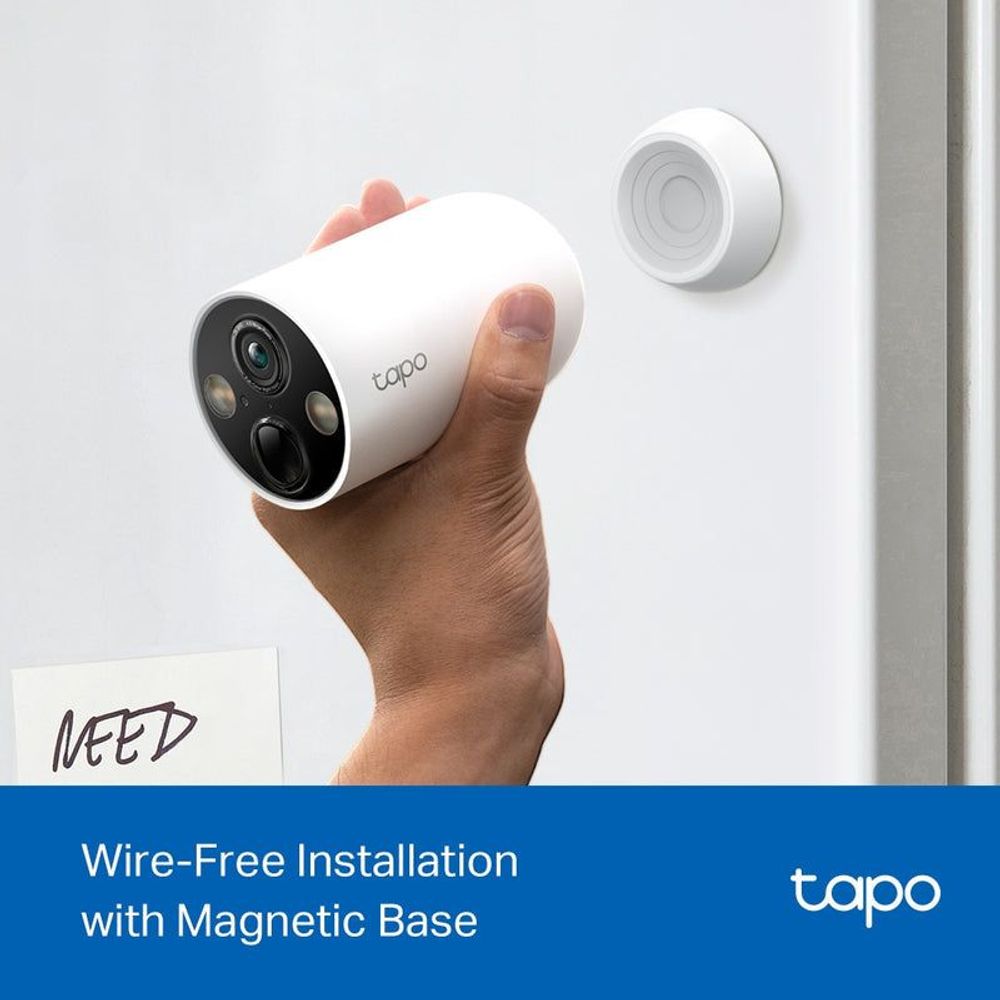 White wire-free security camera held on a wall by magnetic base with black front