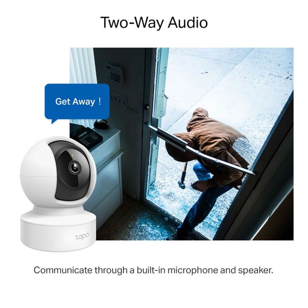 White indoor pan-tilt security camera placed near open doorway