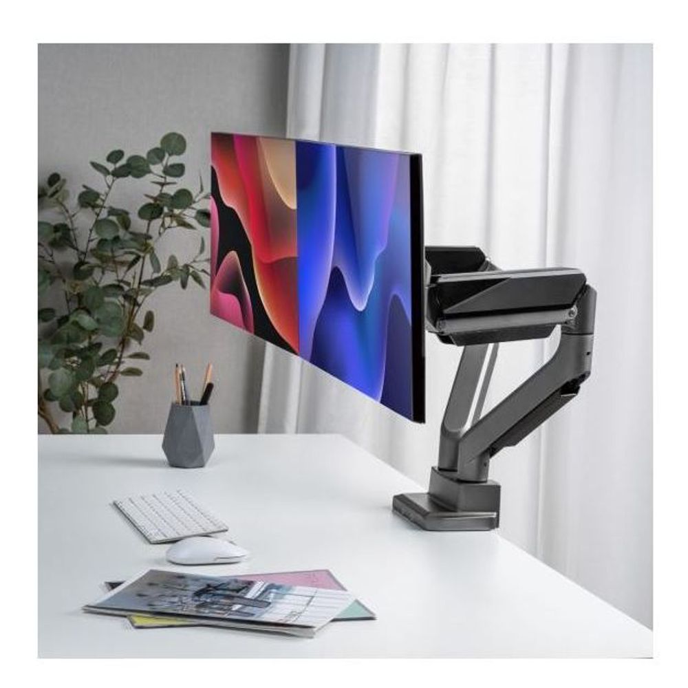 Dual monitor arm holding two flat screens, matte black arms and silver pole