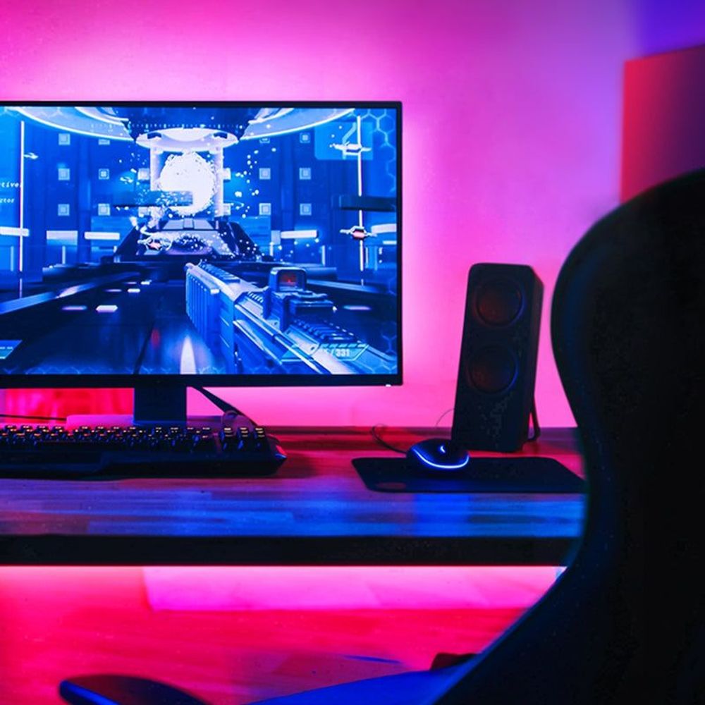 Smart Wi-Fi light strip creating colorful LED lighting in a home workspace