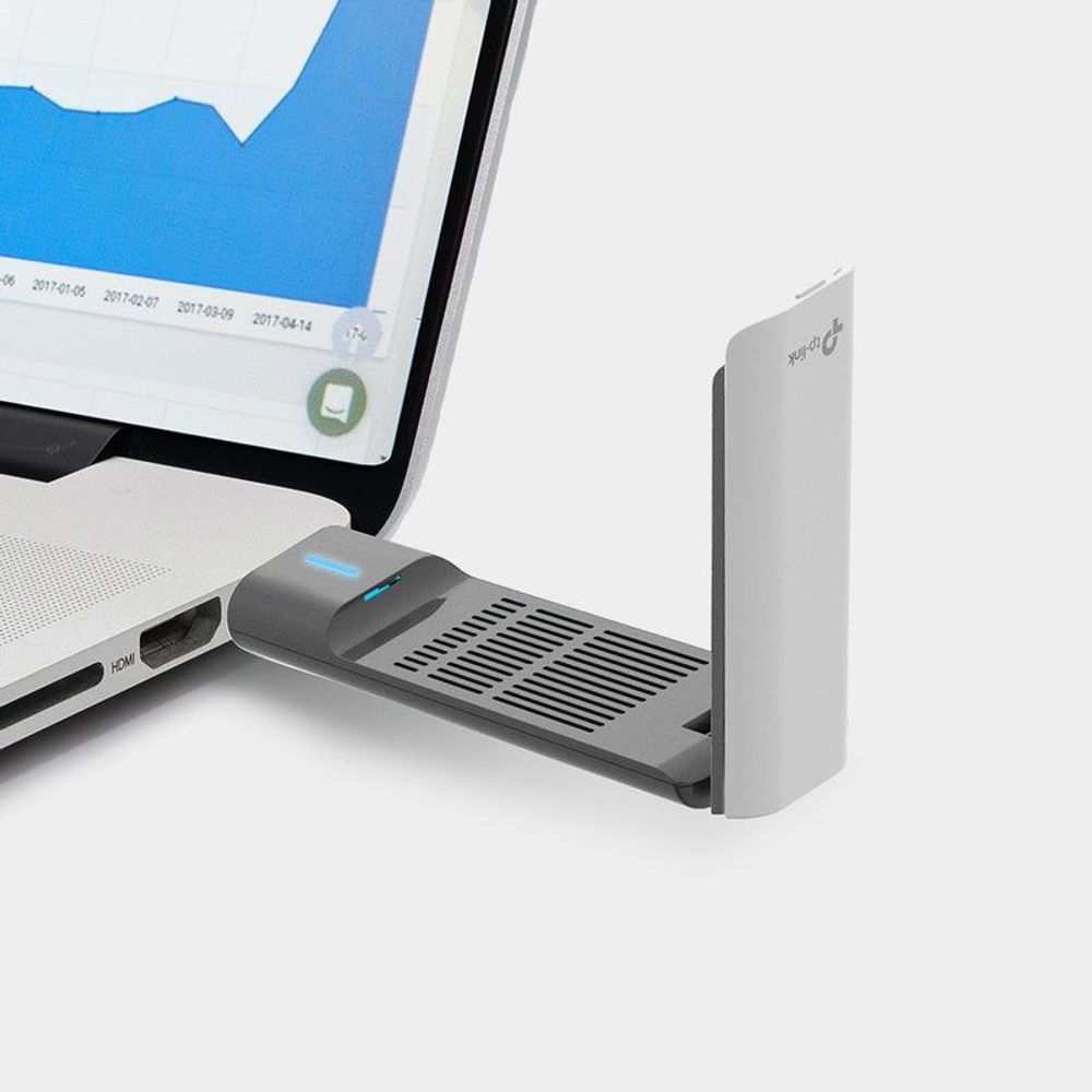 High-gain wireless USB adapter with black antenna base beside a white router