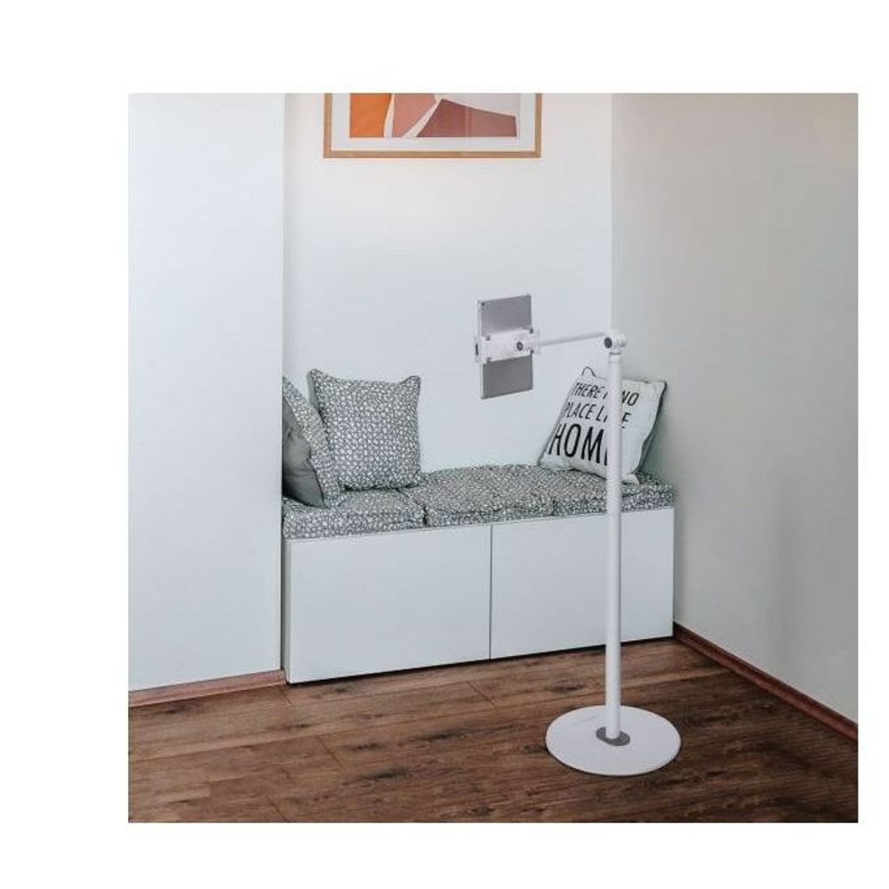 White tablet floor stand with round base and wall-facing adjustable mount
