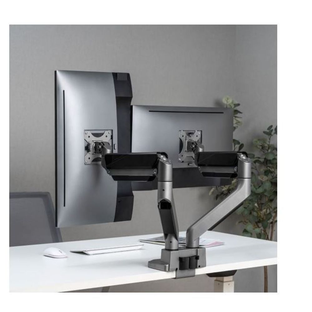 Dual monitor arm with two VESA brackets on a desk, silver support and black arms