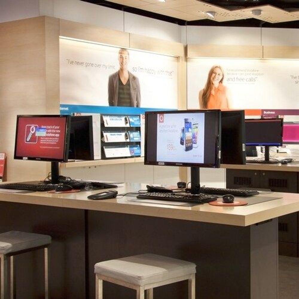 Black flat panel monitor mounts on a counter-top workstation desk