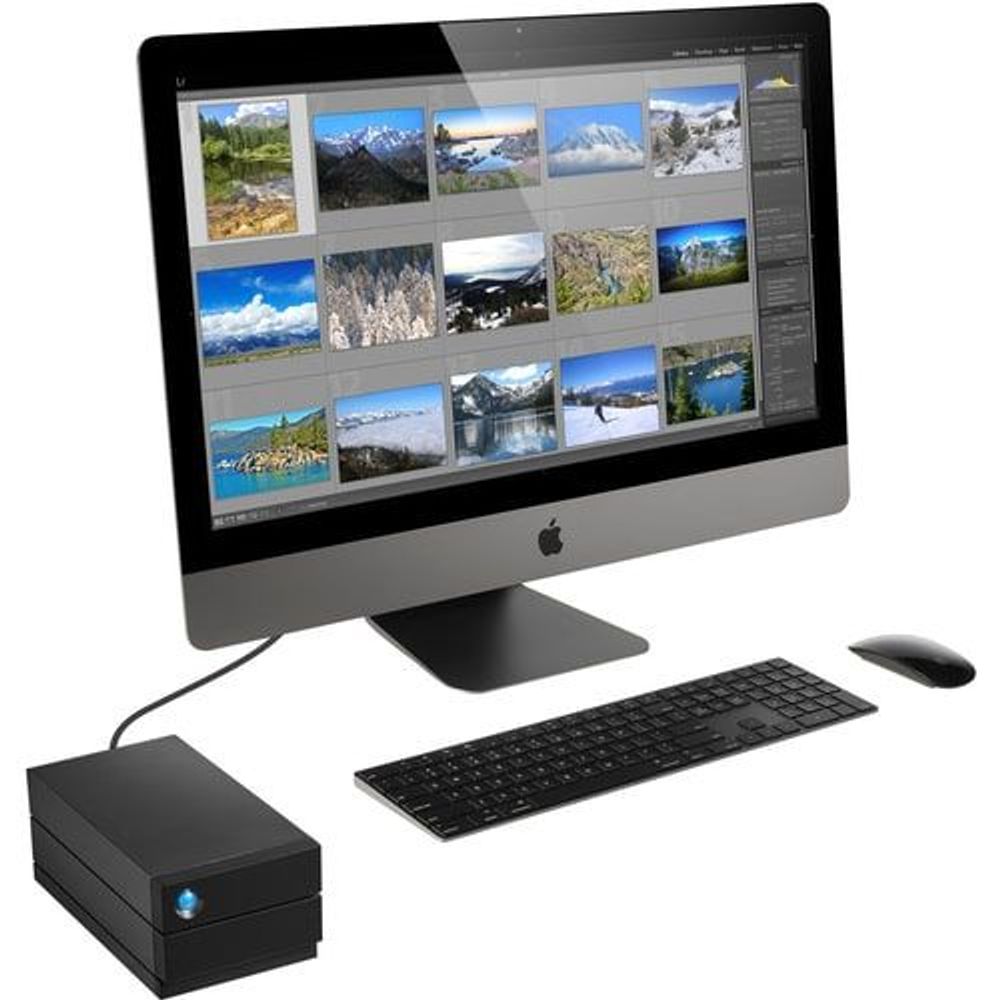 Black desktop RAID storage connected to a computer setup with blue status light