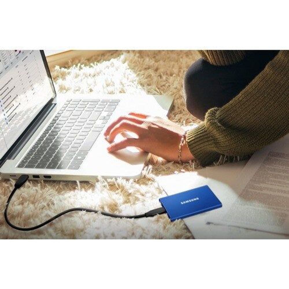 Samsung T7 portable SSD blue connected to laptop via USB cable