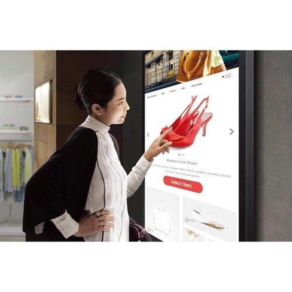 32-inch touchscreen digital signage display with a shopper touching the screen