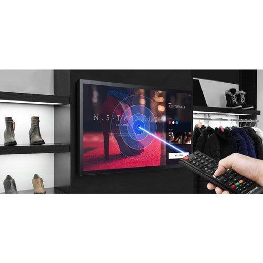 32-inch touchscreen digital signage display with remote control interacting in store