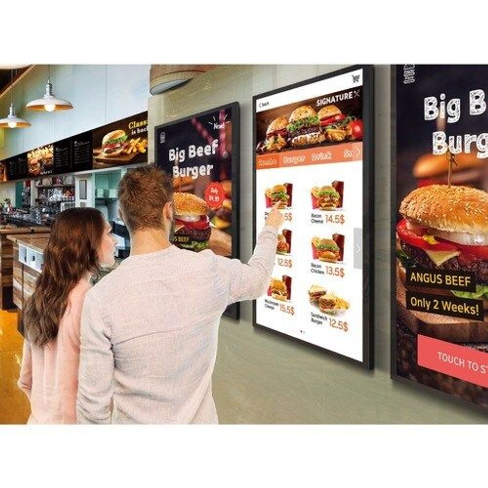 32-inch touchscreen digital signage display on a fast-food counter, item menu visible