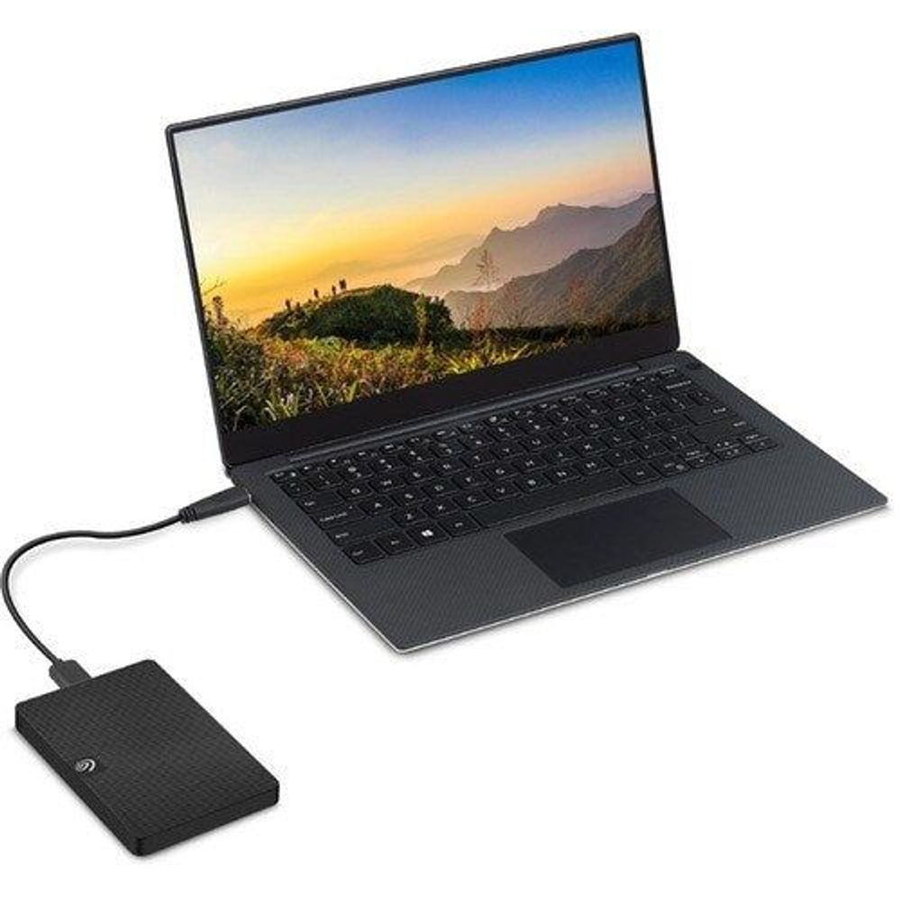 Black portable hard drive connected to a laptop via cable