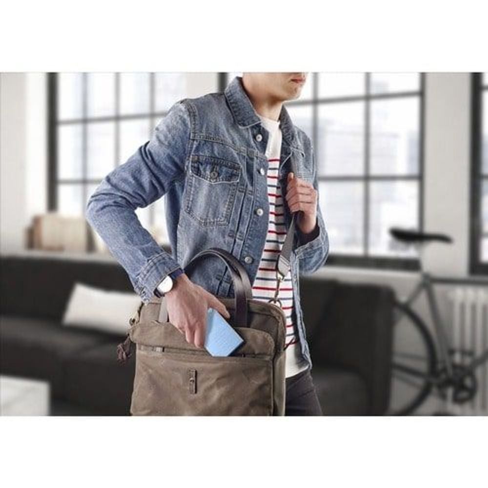 Light blue portable hard drive shown for on-the-go transport with a tote bag