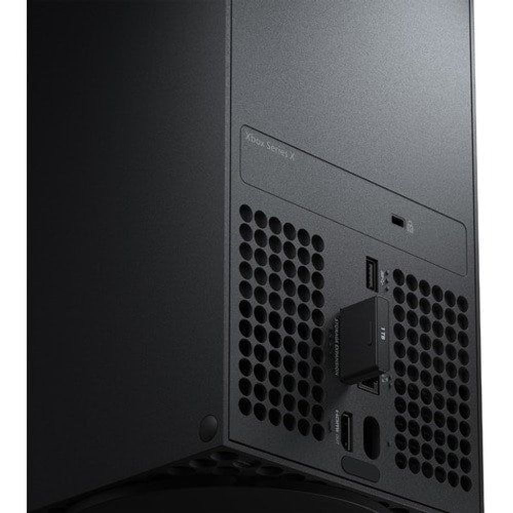 Seagate 1TB SSD card installed at the rear of a console with vent pattern