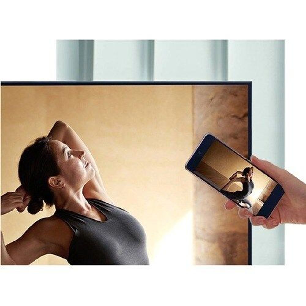 Black Samsung 75-inch Smart LED-LCD TV with woman on screen and phone control