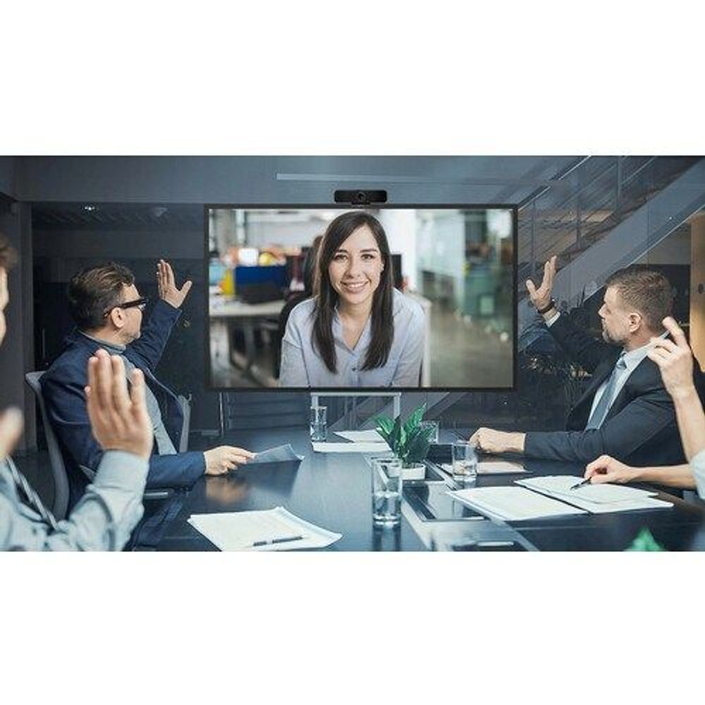Large LCD digital signage display showing video call in office meeting room