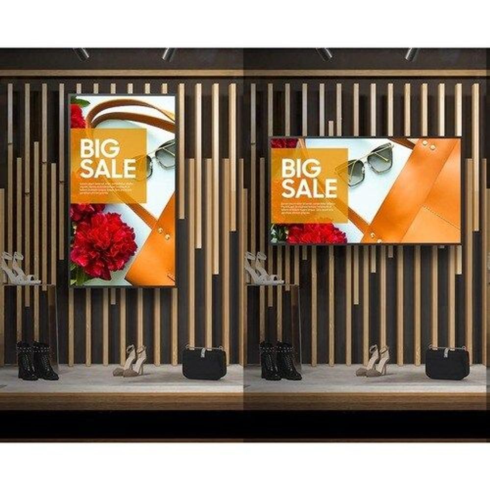 Two LCD digital signage displays showing big sale promotional graphics on wood slats
