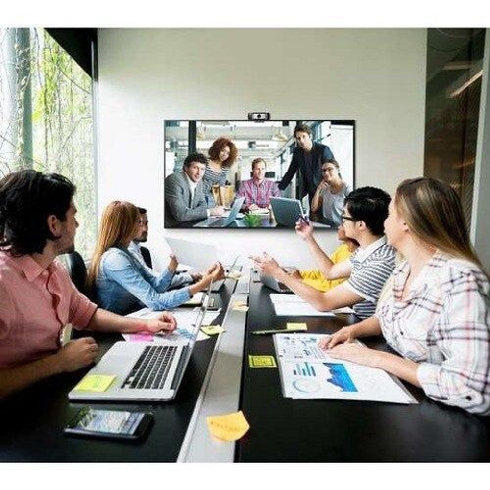 Samsung 65-inch professional LCD display showing meeting participants on screen
