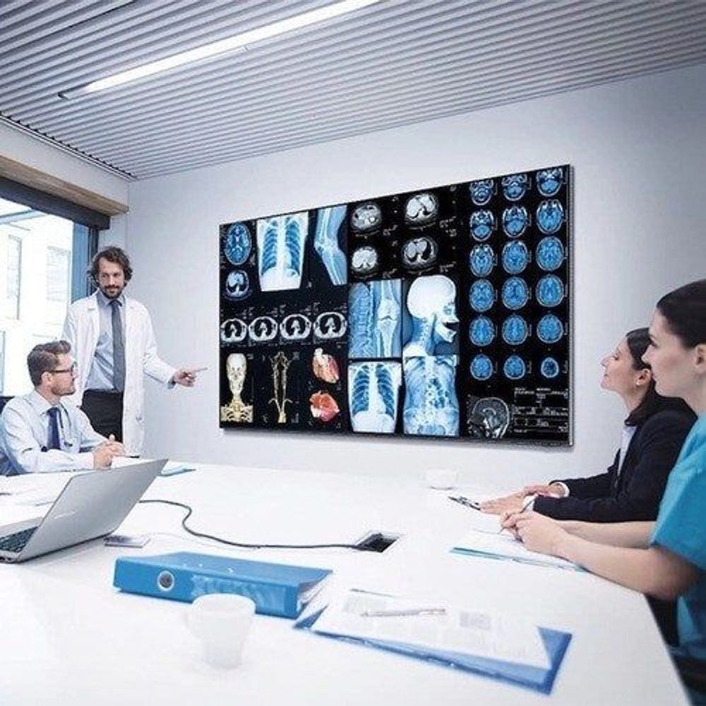 Samsung QHB professional display wall-mounted showing medical-style images