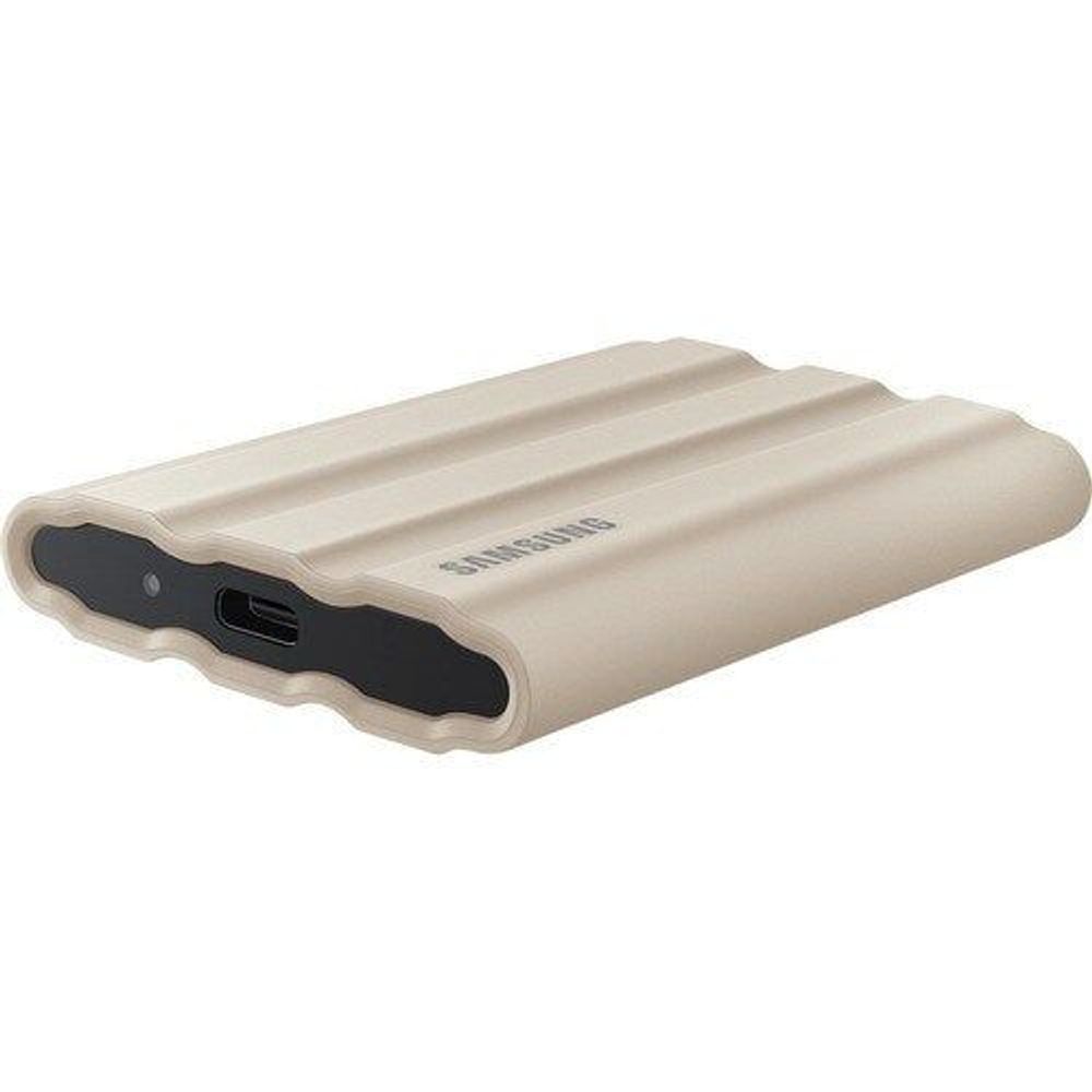 Beige Samsung T7 Shield portable SSD with black port panel and USB-C opening