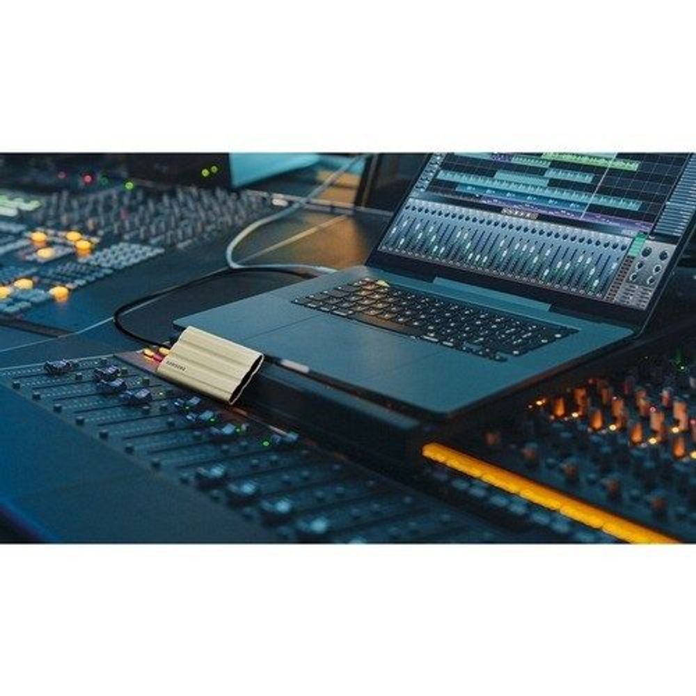 Samsung Portable SSD T7 Shield connected by cable on laptop workbench