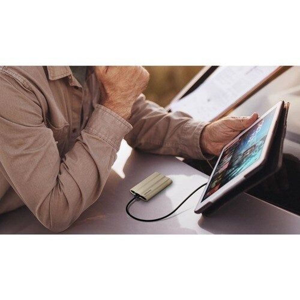 Samsung Portable Rugged SSD T7 Shield connected to tablet in use, black drive visible