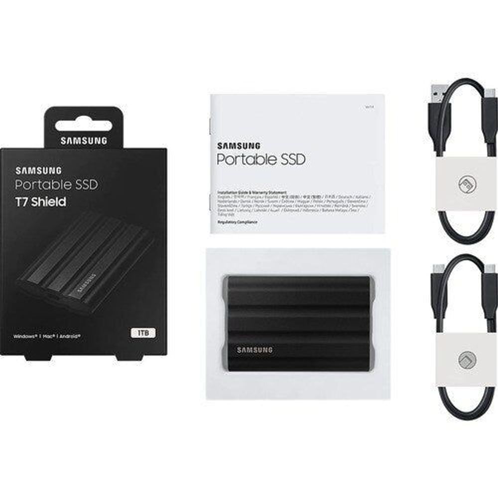 Portable SSD bundle: black SSD, packaging, and USB cable set