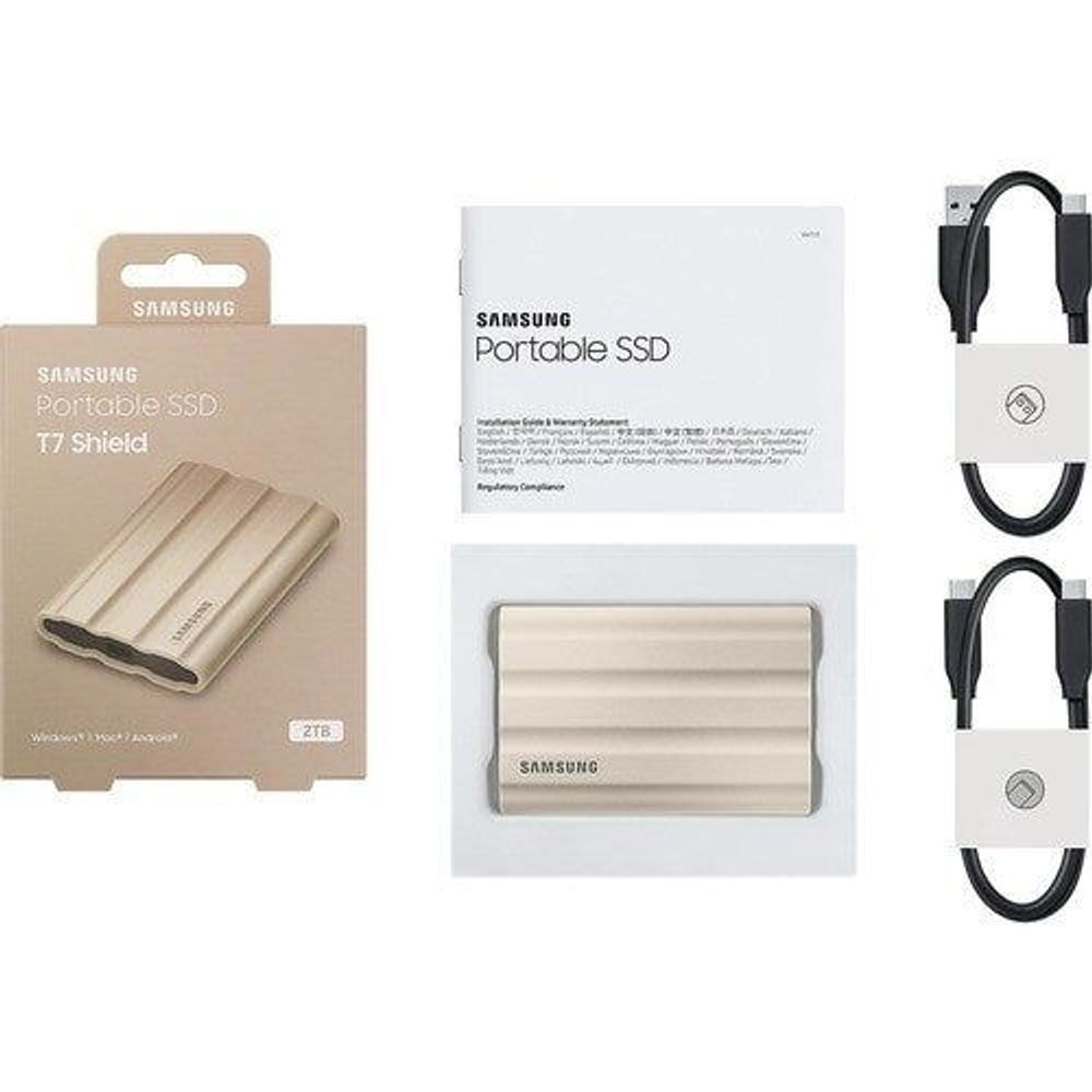 Samsung Portable SSD T7 Shield bundle: beige drive, cables, and packaging.