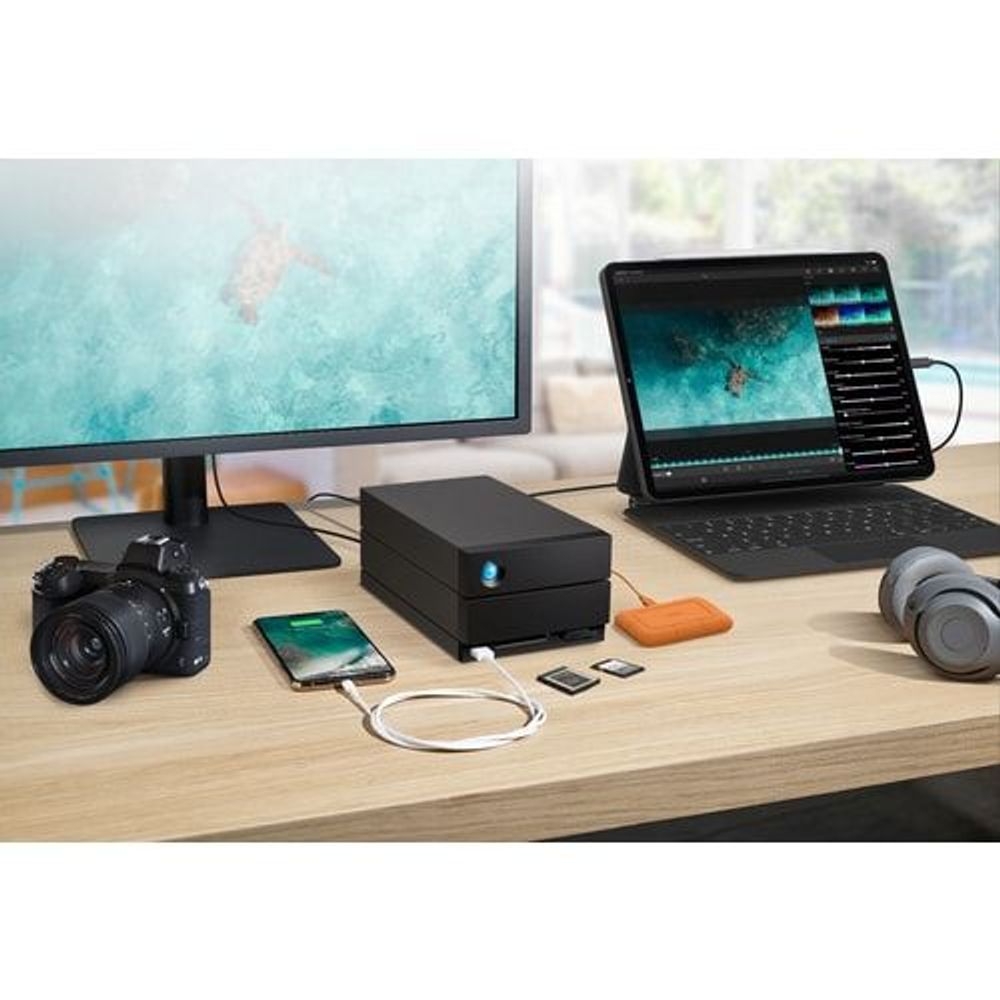 Dock storage system on desk with camera, phone, and laptop for media workflow