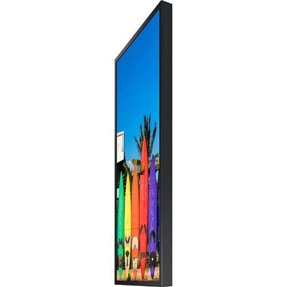 Digital signage display angled side view showing colorful surfboard image