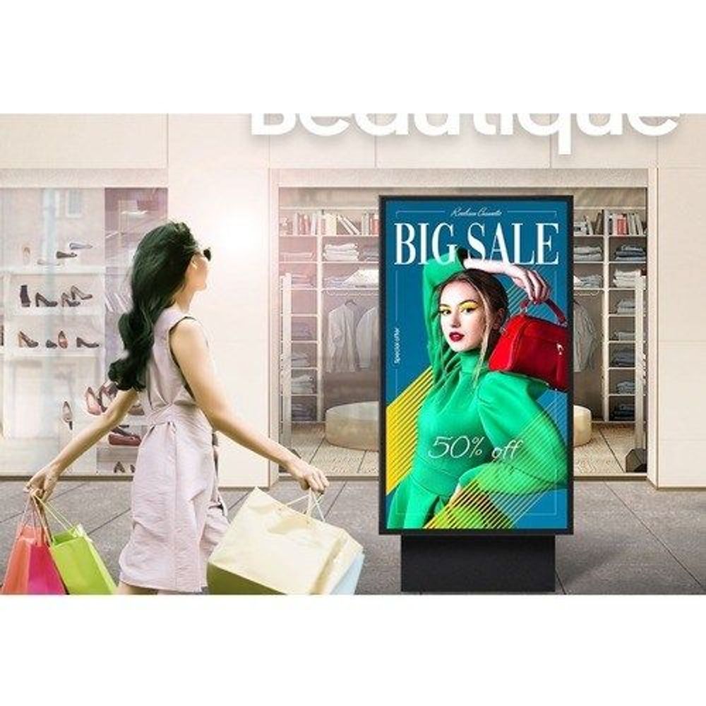 Outdoor LCD display showing in-store sale ad with shopper bags