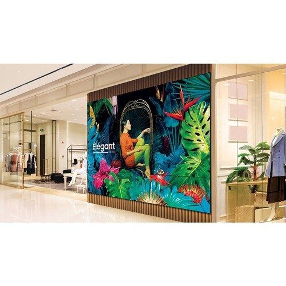 Samsung 55-inch LCD digital signage display mounted in a wall with colorful tropical image
