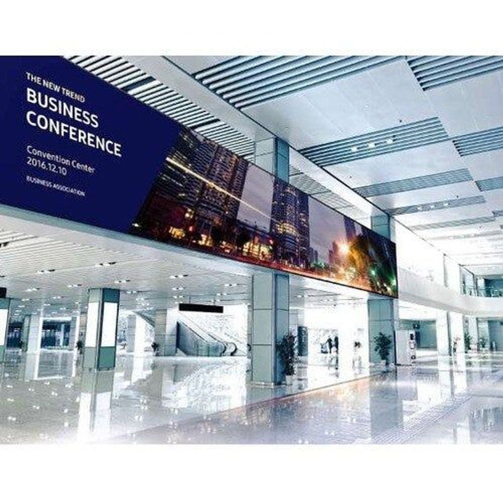 55-inch LCD digital signage display showing business conference slide on screen