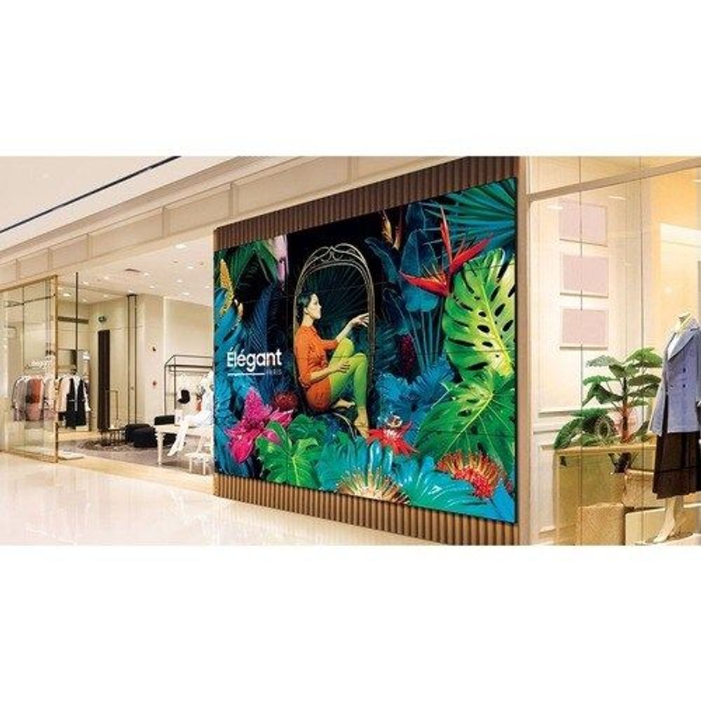55-inch digital signage LCD display in a shop window, showing colorful tropical artwork