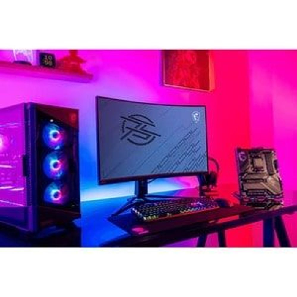 Gaming motherboard displayed on a desk with RGB PC components
