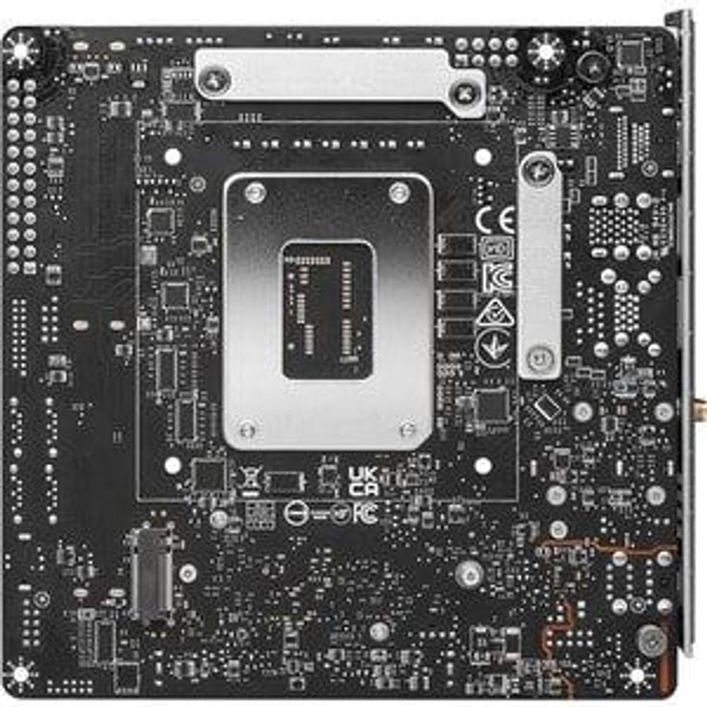 Gaming desktop motherboard underside view with central chip socket area, dark PCB