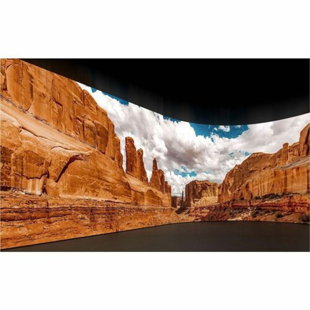 Digital signage display showing a desert canyon landscape on the screen