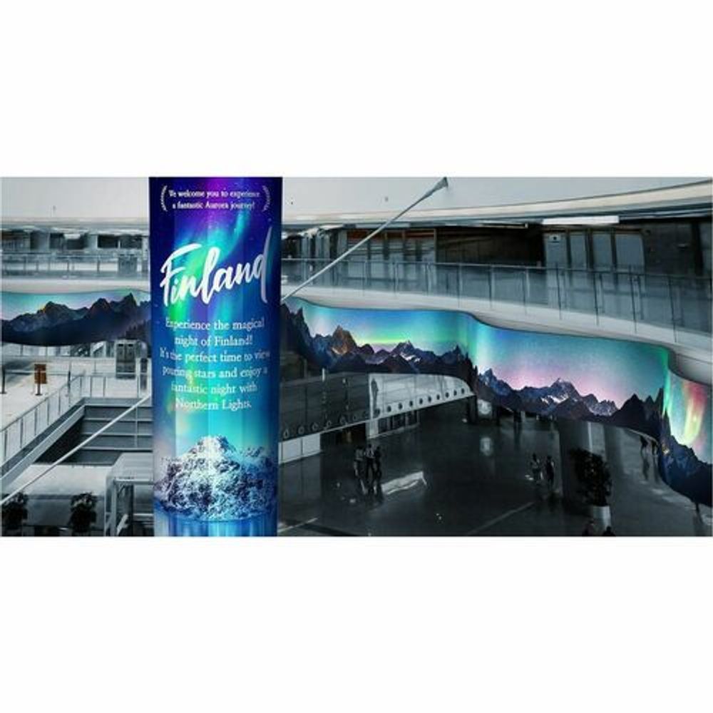 Indoor digital signage LCD display with blue travel-themed promotional graphics