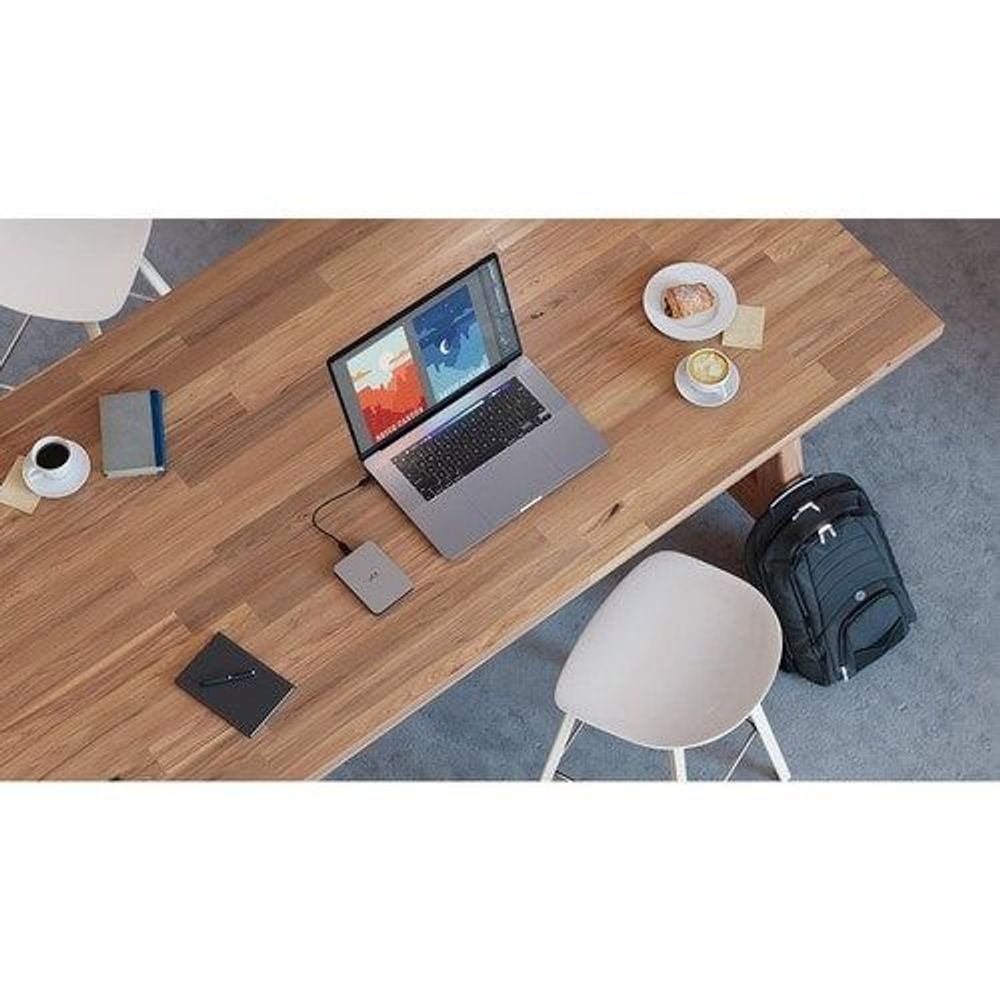 Portable 2.5 in hard drive connected to laptop with USB cable