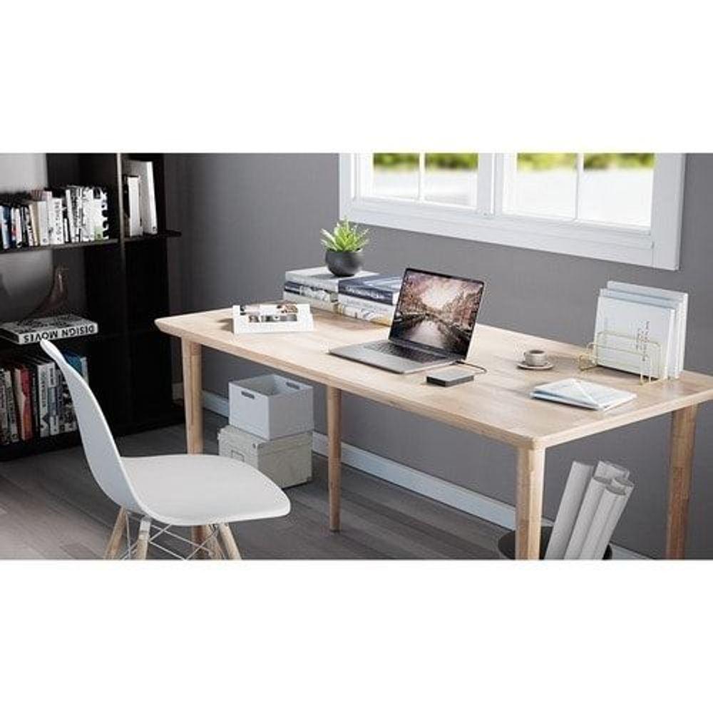 Portable hard drive on desk near laptop in home office