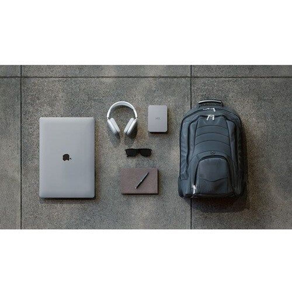 LaCie portable hard drive shown with other desk accessories on a floor surface.